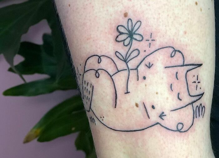 Simple outline tattoo of a cat with a flower on its back, symbolizing self-love and empowerment.