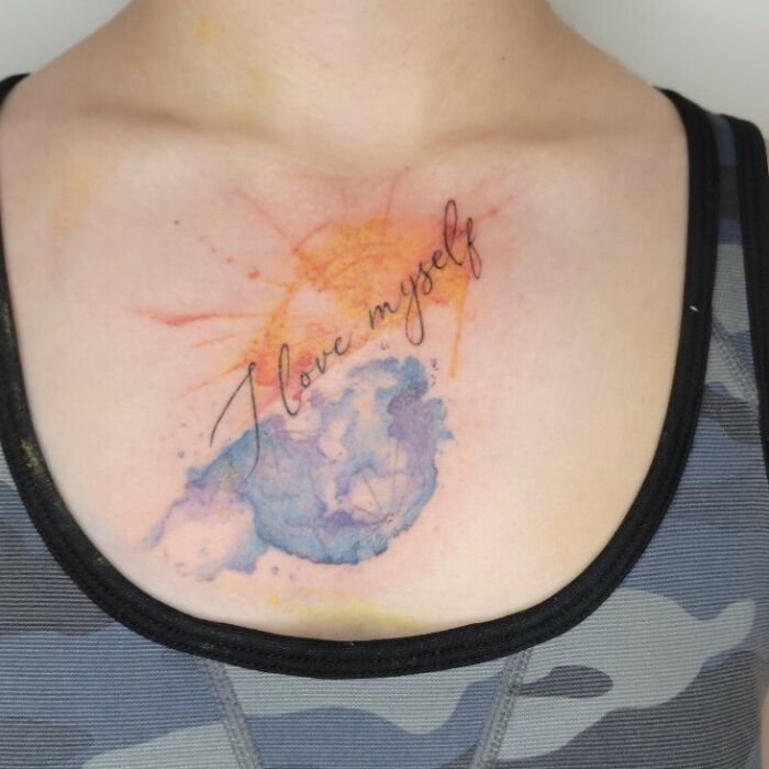 Chest tattoo with watercolor design, featuring the phrase "I love myself" to express self-love and empowerment.
