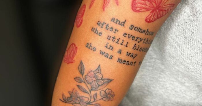 Self-love tattoo with flowers and butterflies, featuring "And Somehow After Everything She Still Blooms" phrase.
