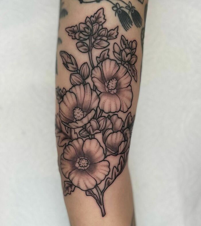 Elegant flower tattoo design on forearm, showcasing intricate floral details and beauty.