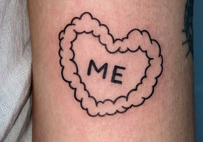 Heart-shaped self-love tattoo with "Me" inside, symbolizing self-importance and self-care.