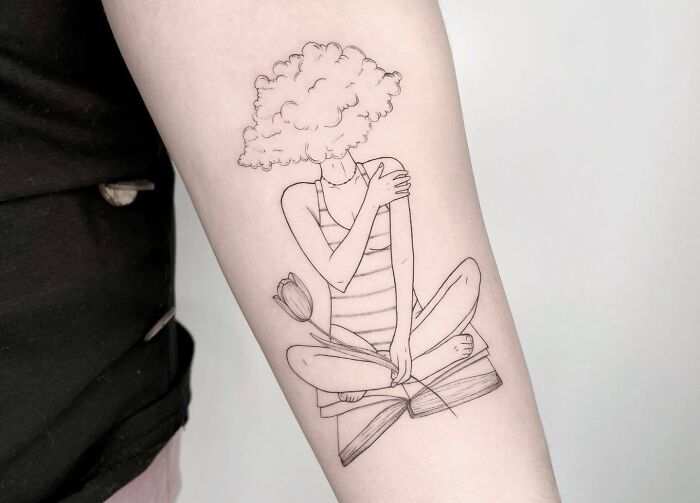 Self-love tattoo of woman in lotus pose with cloud head, embracing herself.