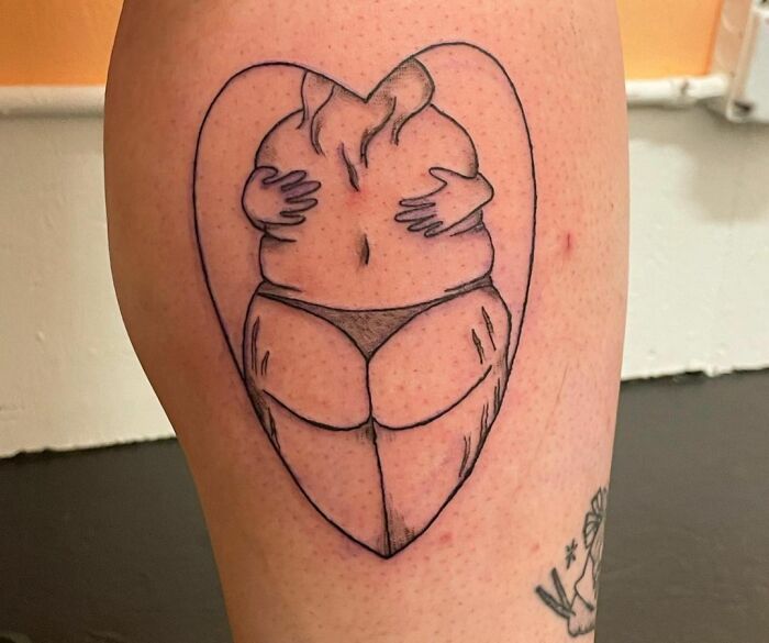 Self-love tattoo featuring a self hug inside a heart symbol, emphasizing self-appreciation and identity.