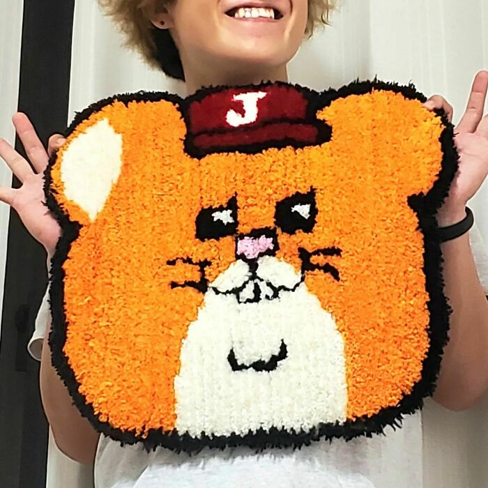 Colorful brown hamster with red hat rug