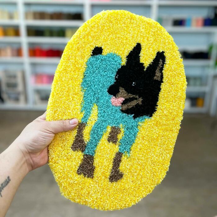 Black dog with blue clothes rug