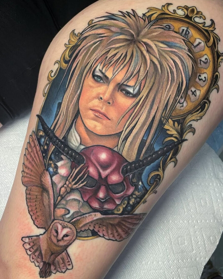 Colorful goblin king tattoo with owl, showcasing amazing realistic detailing.