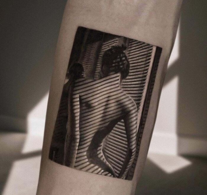 Realistic tattoo of a woman's silhouette with shadowy blinds effect on skin.