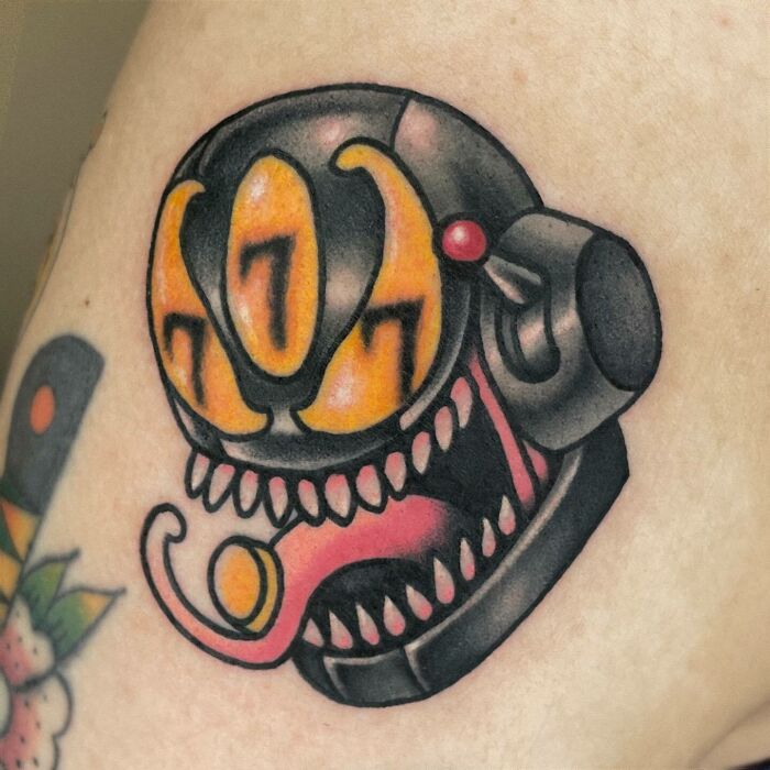 Tattoo of Venom with bold colors and exaggerated features, illustrating Marvel comic art style.
