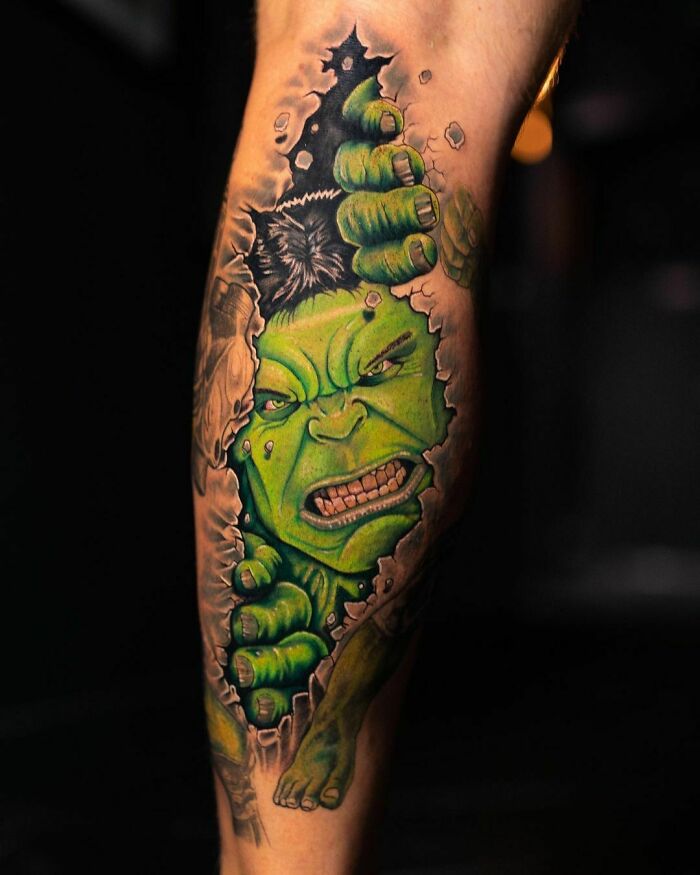 Marvel tattoo of Hulk breaking through skin on a leg.