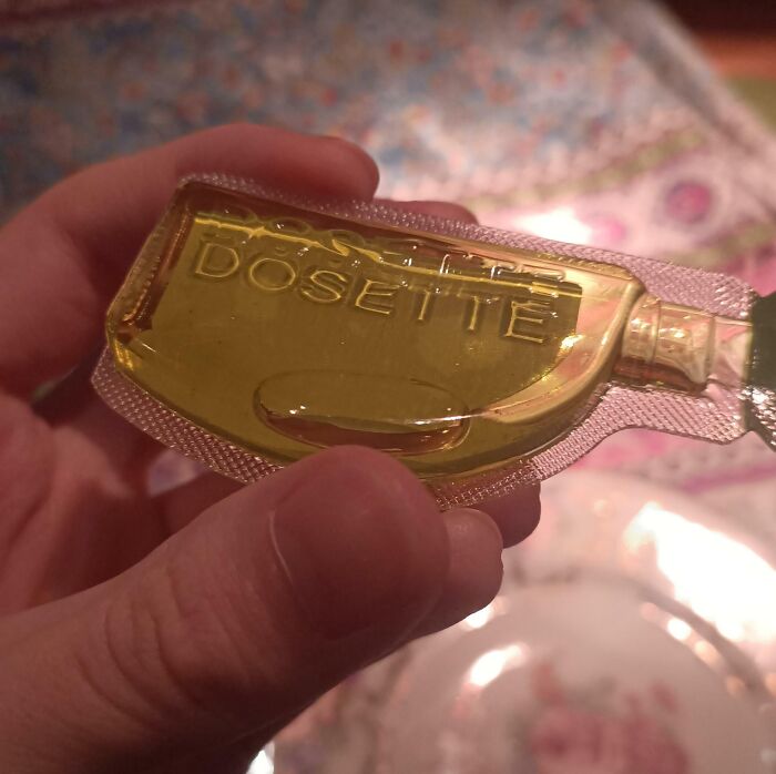 The Logo On This Package For Olive Oil Is Visible As A Shadow Cast By The Plastic