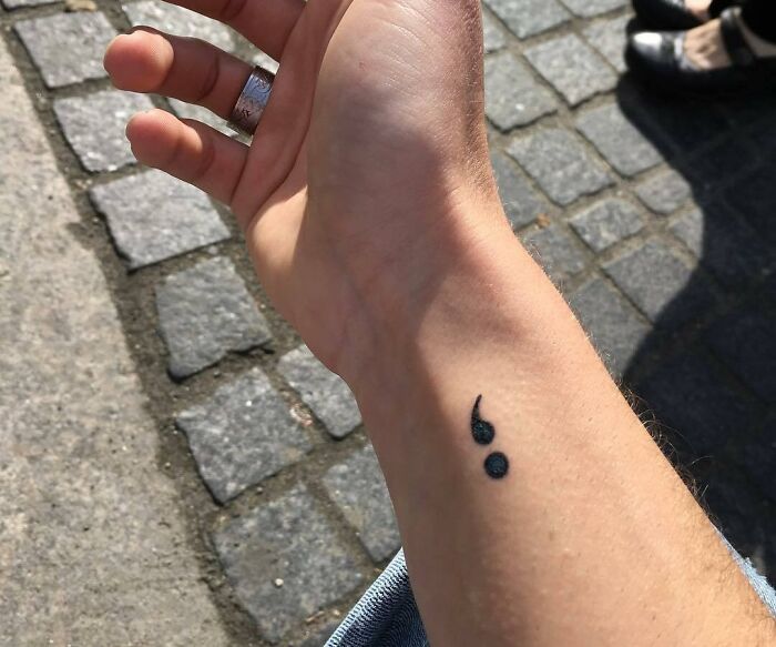 Wrist tattoo of a small semicolon on the inner forearm, representing personal meaning, inspired by celebrity tattoos.