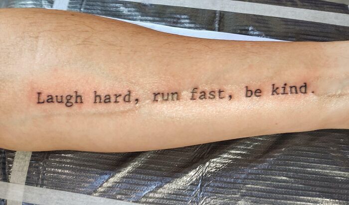 "Forearm tattoo with the words 'Laugh hard, run fast, be kind' as part of word tattoo ideas for new ink."