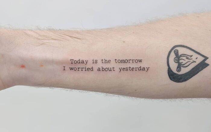 Word tattoo idea on forearm: “Today is the tomorrow I worried about yesterday” next to a heart symbol.