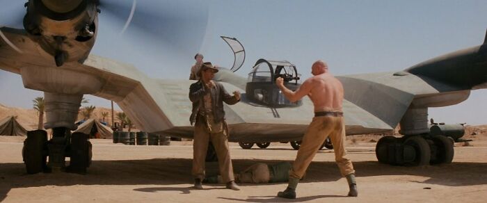 ndiana Jones fighting with Tough Mechanic in the desert 