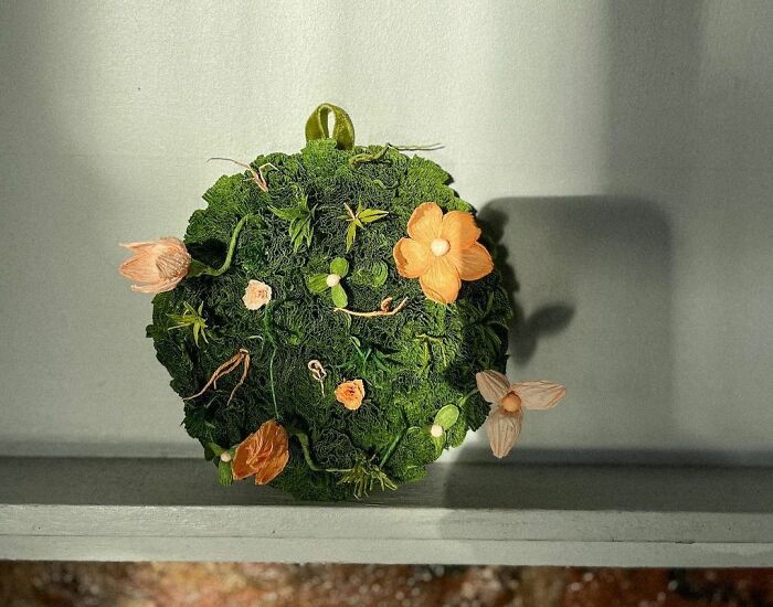 a circle of grass and flowers made out of a paper