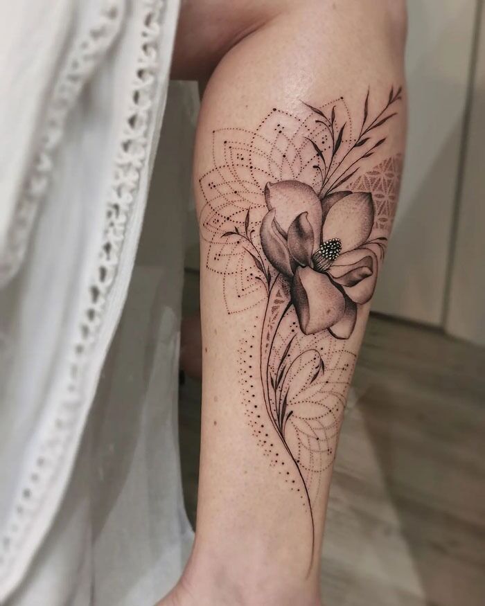Elegant flower design calf tattoo, featuring intricate patterns and shading for a unique style.