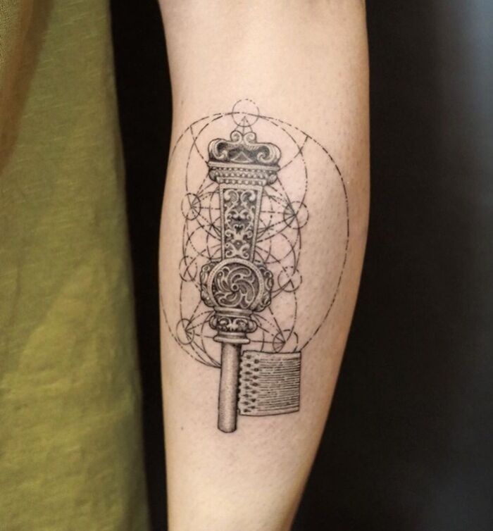 Intricate calf tattoo featuring geometric patterns and intricate designs.