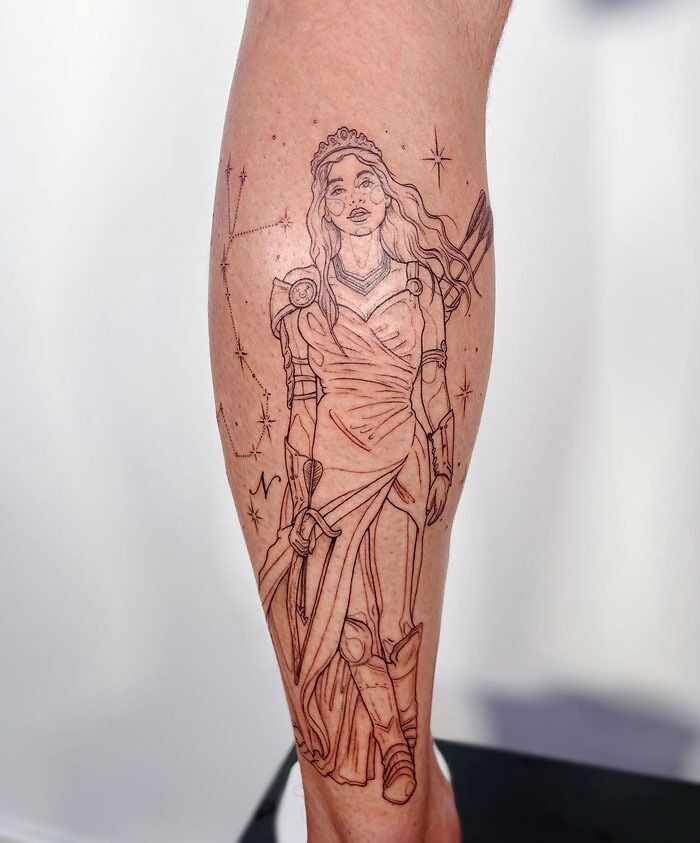 Unique calf tattoo depicting a warrior woman with constellations and stars.