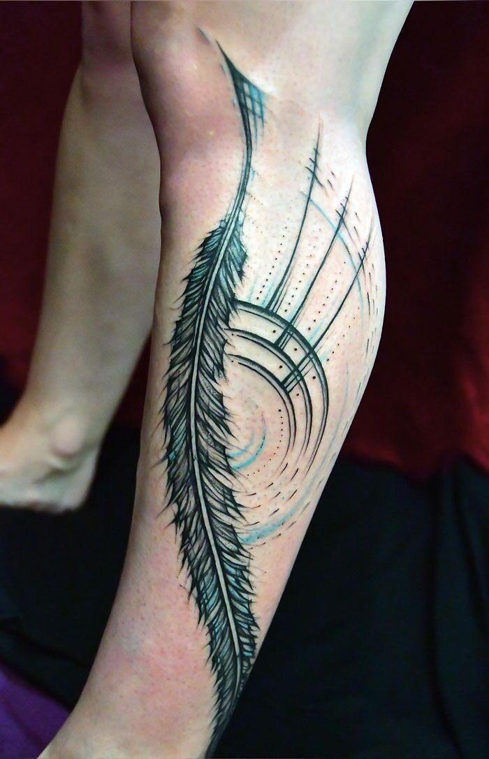 Unique calf tattoo featuring a detailed feather design with geometric elements.