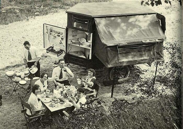 A Group Camping In The 1920s With A Tent Trailer Kitchen
