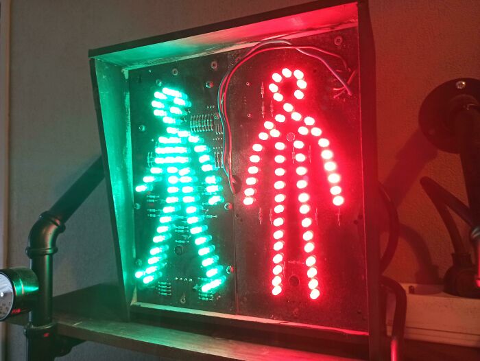 Pedestrian traffic light gadget with red and green LED figures.