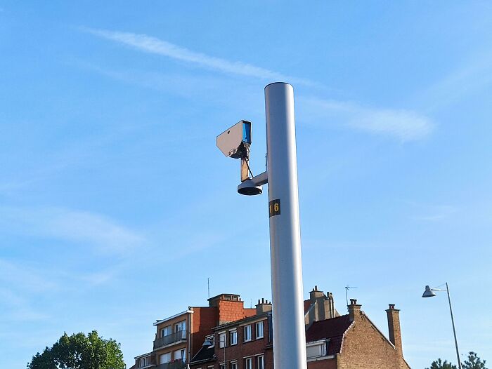 Modern urban surveillance camera in a city setting.