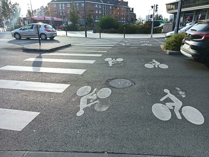 Crosswalk and bike lane in urban setting, showcasing city gadgets.