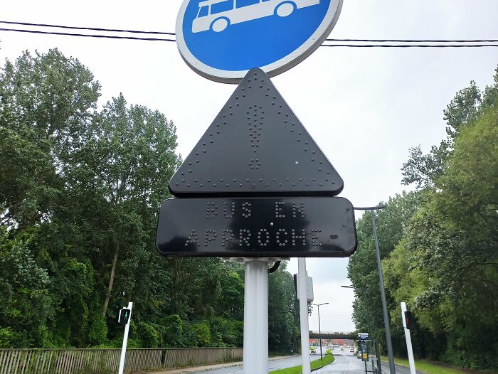 Bus stop sign with "Bus en approche" text, featuring a unique gadget for improved navigation in urban areas.