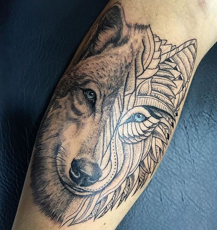 Wolf tattoo with intricate geometric design, celebrating the animal kingdom on a forearm.