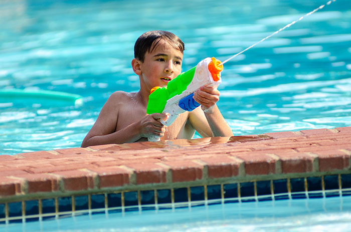Kid playing with water gun
