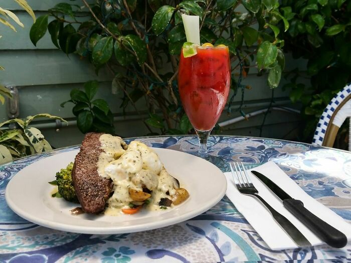 Coctail and steak on restaurant table