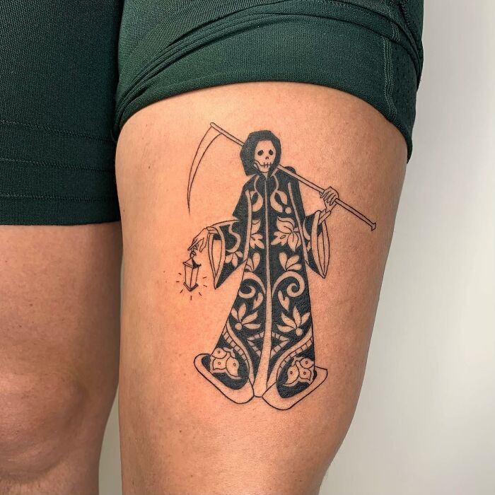 Illustration-style tattoo of a cloaked skeleton holding a scythe and lantern, designed by a skilled artist.