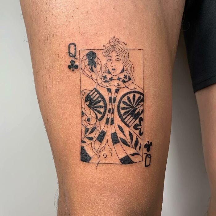 Tattoo of Queen of Clubs on calf, designed with illustration style ink, showcasing artistic detail.
