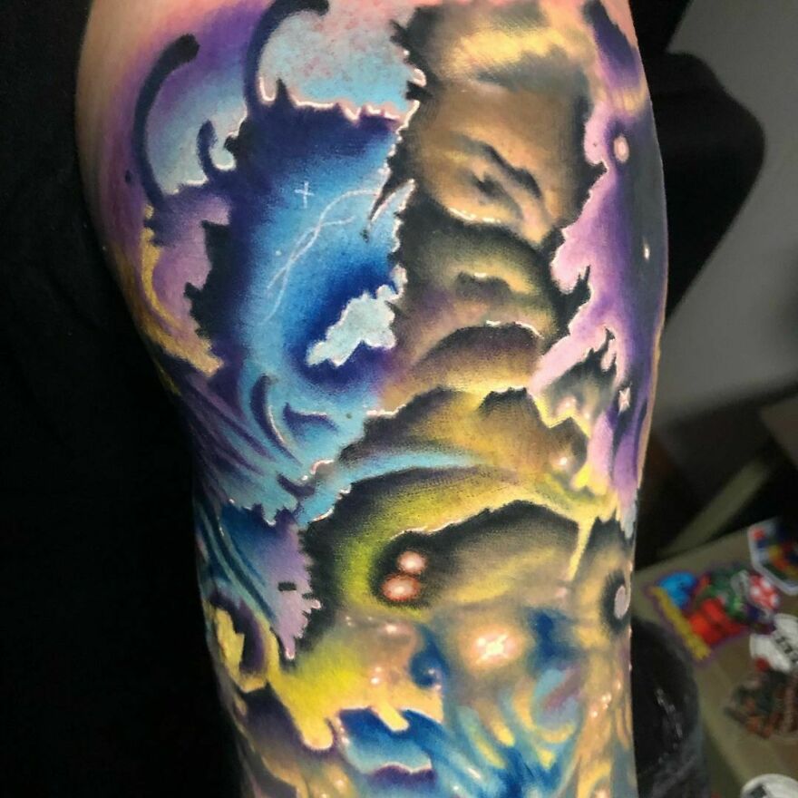 Vibrant space tattoo with cosmic patterns and nebula-inspired colors, showcasing an outer space theme.
