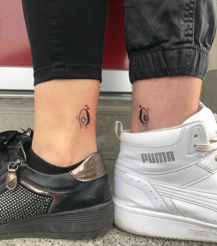 Matching tattoos for couples featuring a cute avocado design on two ankles, showcasing their special bond.