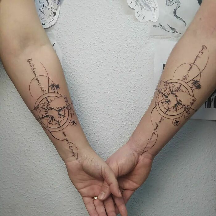 Matching compass tattoos on forearms, symbolizing shared journeys and connections with special people.