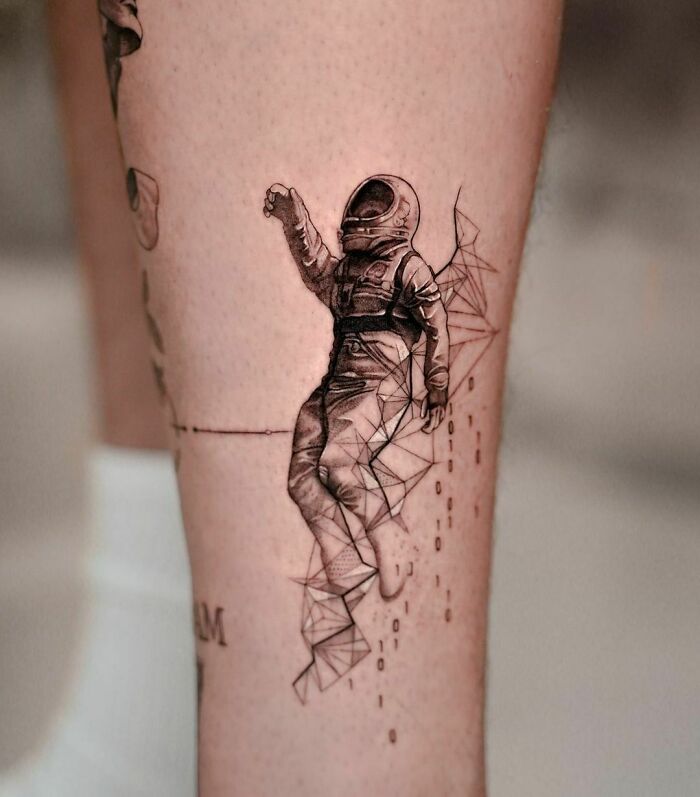 Tattoo of an astronaut with geometric designs, perfect for astrology fans who love space-themed art.