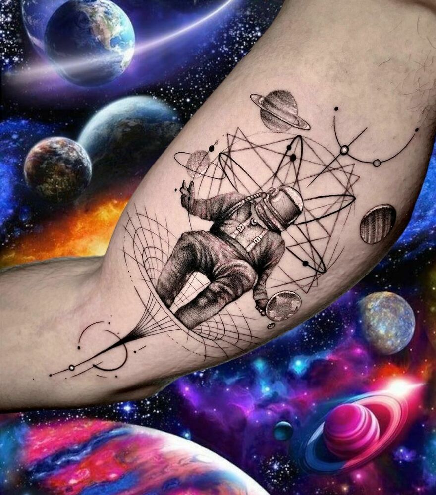 Astronaut tattoo with planets and geometric patterns, showcasing outer space cool.