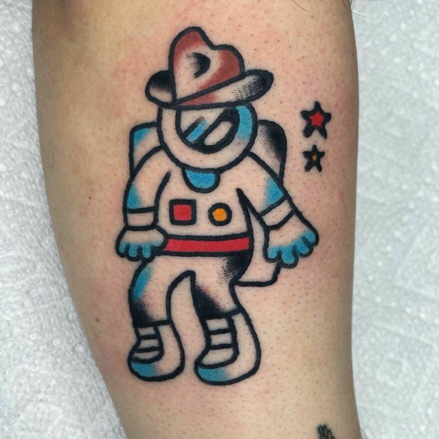 Colorful cartoon astronaut tattoo with stars, representing outer space cool theme.