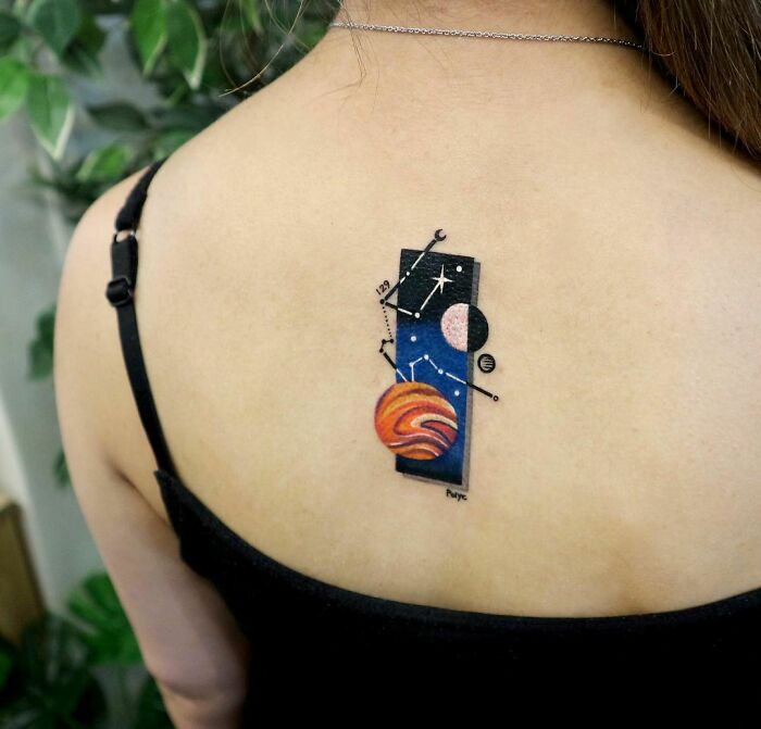 Space tattoo featuring planets and constellations on a person's back, ideal for astrology fans.