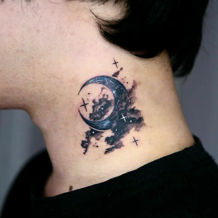 Space tattoo featuring a crescent moon and stars on the neck.