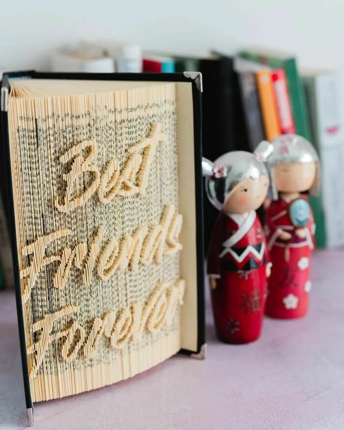 an opened book with a phrase cutten from the pages