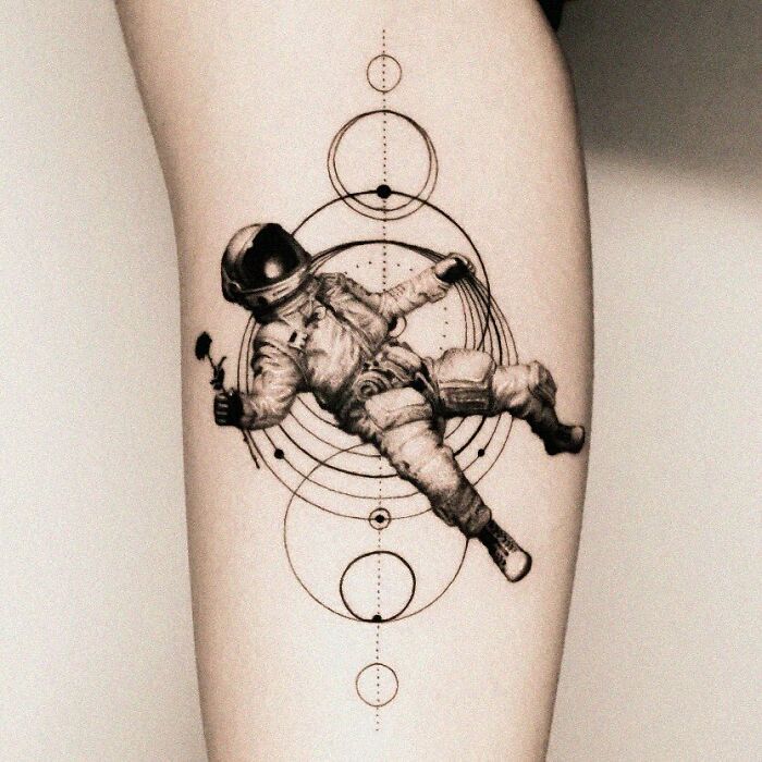 Astronaut tattoo with celestial design, perfect for astrology fans.