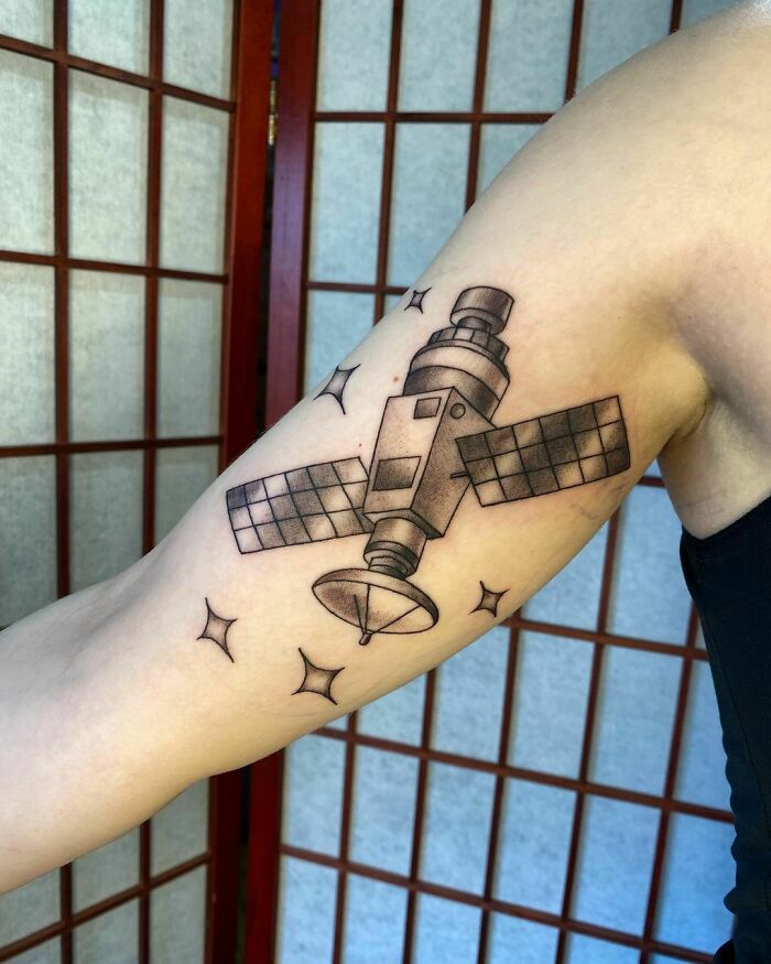 Arm tattoo of a satellite design with stars, perfect for astrology fans seeking space-themed ink.