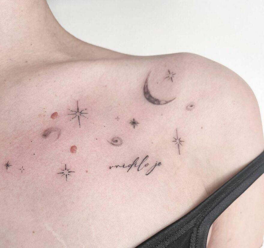 Outer space tattoo on shoulder featuring stars, crescent moon, and small planets in minimalist design.