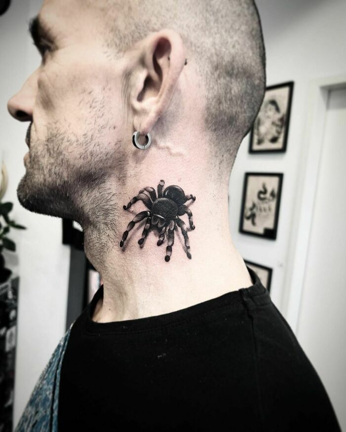 Tattoo of a realistic tarantula on a man's neck, showcasing animal tattoos celebrating the animal kingdom.