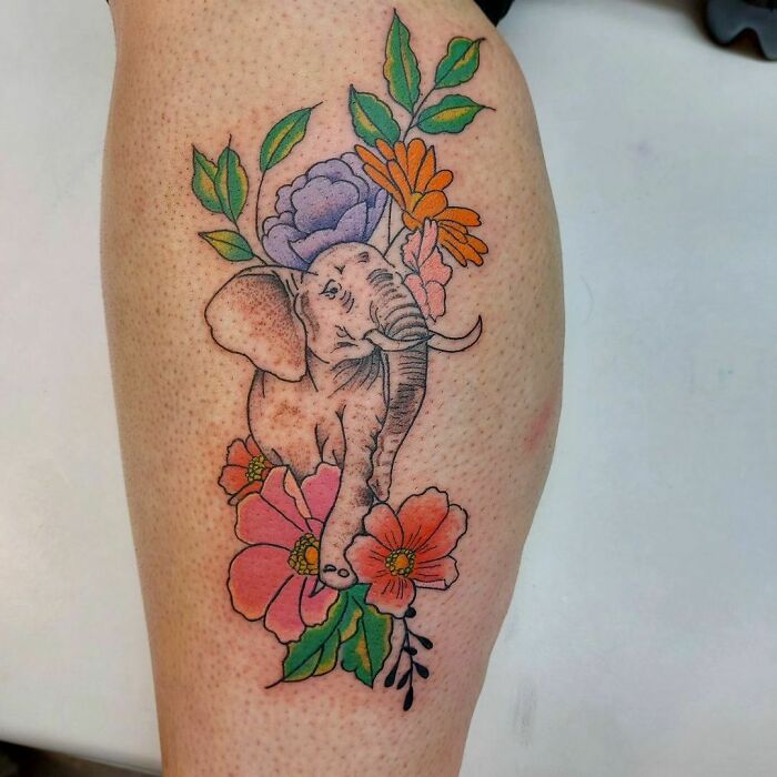 Elephant and colorful flowers calf tattoo idea, showcasing unique and cool design elements.