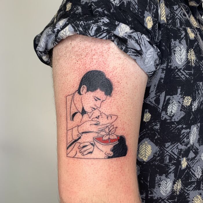 Tattoo artist creates an illustration-style tattoo on a person's upper arm, depicting a vintage romance scene.