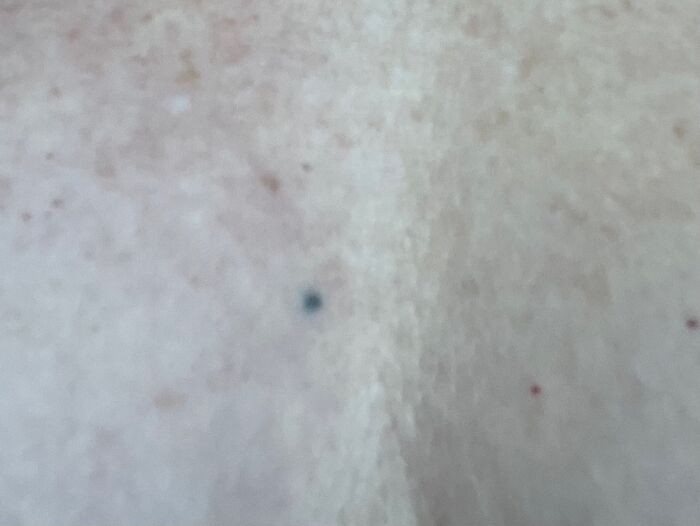 A close-up of a small tattoo on skin, showcasing unique ink design.