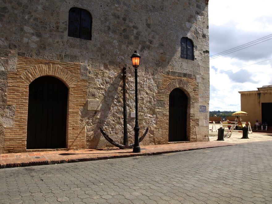 A Colonial Building's Facade With An Anchor Rested On Its Wall